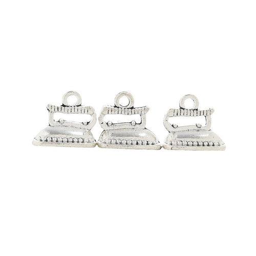 Grouped miniature clothes iron components showing repeated front details and finish
