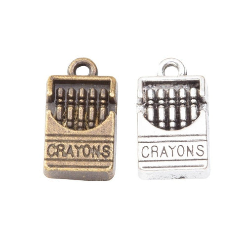 Front and reverse details of crayons box charms on a white background