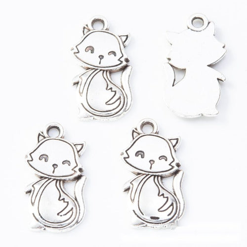 Scarf-wearing cat metal component, front and reverse detail on white
