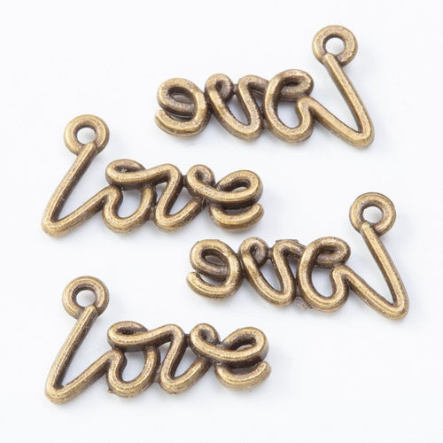 Close view of the love script charm showing its raised front pattern