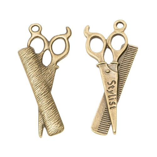Detail view of scissors and comb charm showing finish variation 2