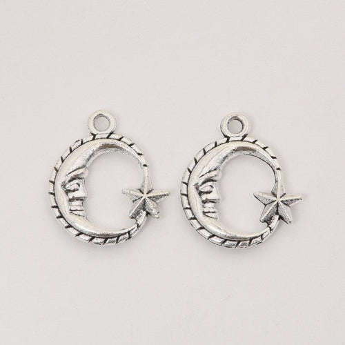 Close front view of moon and star charm showing a crescent frame, face detail, and pointed star