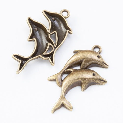 Close-up view of the three dolphin metal charms in five metallic finishes showing its front and reverse metal details.