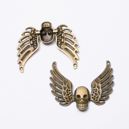 Front and reverse views of the winged skull connector charm