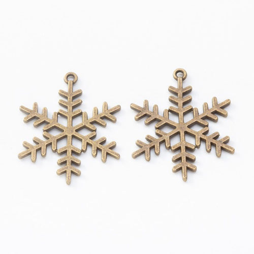 Snowflake metal component, front and reverse detail on white