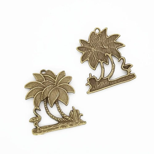 Close view of the front details on twin palm tree charm pendants
