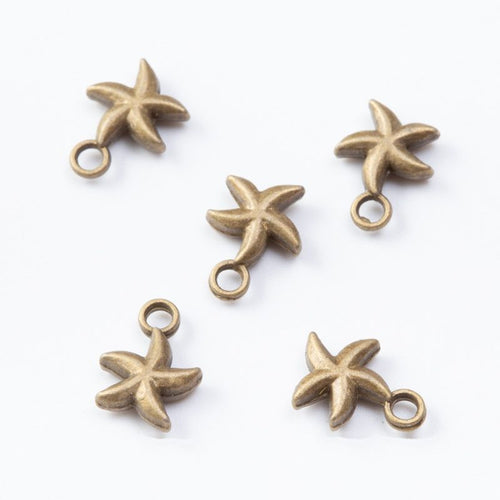 Five-arm starfish charms with softly raised center details shown from the front on a white background.