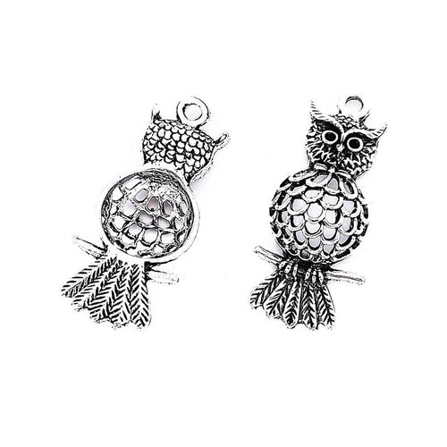 Perched owl metal component, front and reverse detail on white