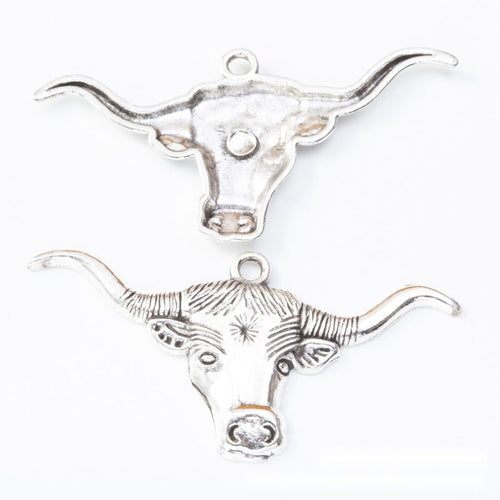 Longhorn cattle head metal component, front and reverse detail on white