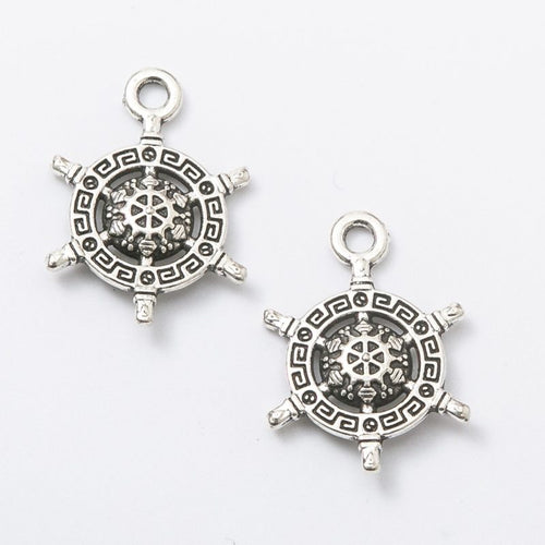 Product photo 2 of the patterned ship wheel charm highlighting its small ship wheel with geometric center pattern