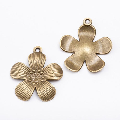 Close product view showing the front and reverse details of the five petal flower charm