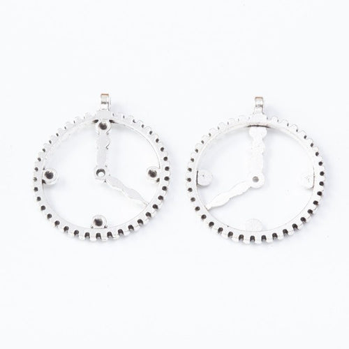 Close front and reverse view of the metal clockwork charm