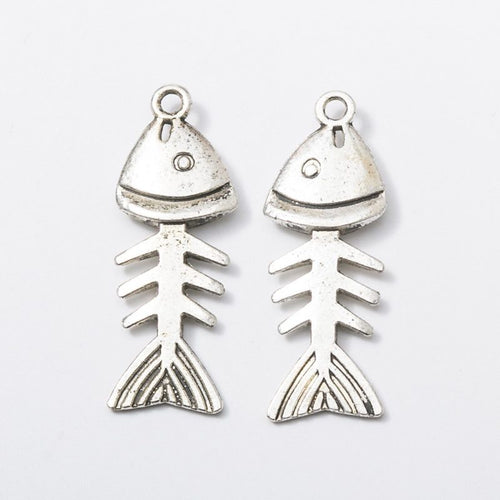 Closer product view of jointed fish skeleton charm shown against a plain background.