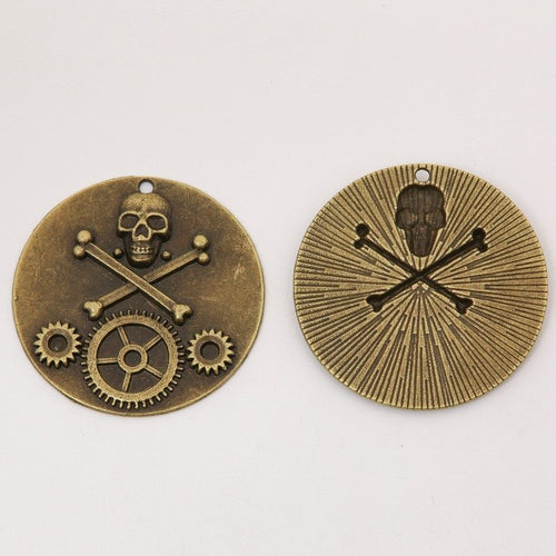 Front and reverse views of the skull gear medallion charm