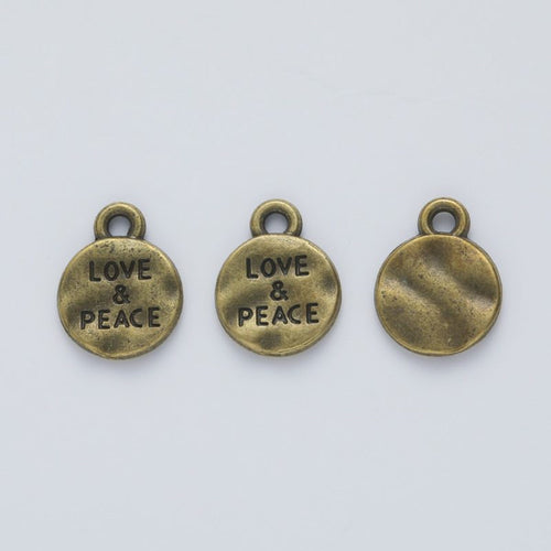 Close view of the LOVE and PEACE charm surface and relief
