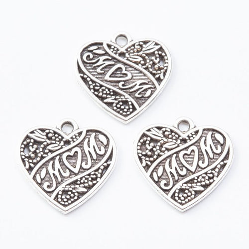 Heart charms with embossed MOM lettering and decorative scrollwork shown from the front on a white background.
