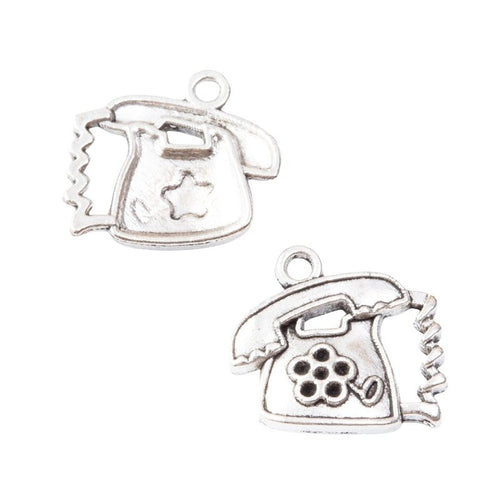 Vintage telephone charms with raised rotary dial details shown from the front on a white background.