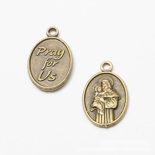 Close view of the an oval devotional medal with a saint figure and Pray for Us lettering