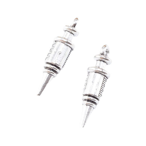 Close view of the syringe shaped charm surface and relief