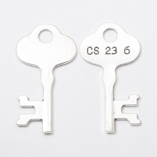Angled detail views of vintage key charms