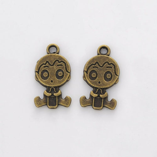 Closer view of the cartoon boy charm surface and hanging loop