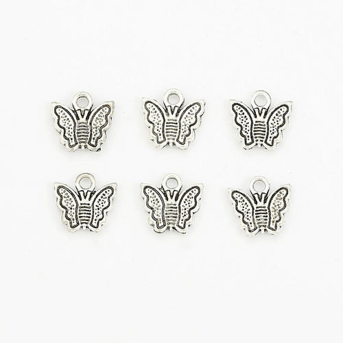 Front and reverse views of the tiny framed butterfly charm