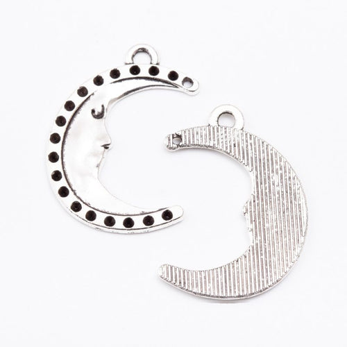 Front detail of crescent moon with dotted edging and loops at both tips