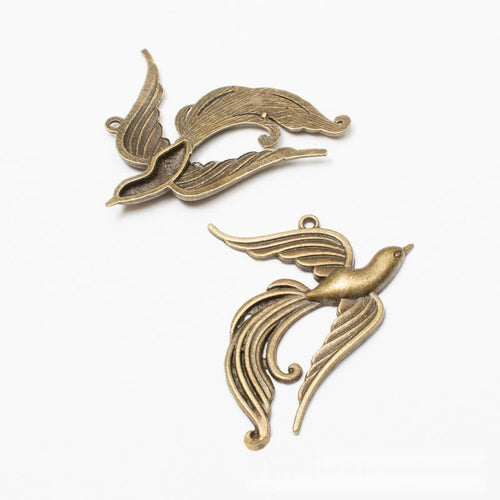 Sweeping Phoenix Bird Charm shown from the front in contrasting finishes