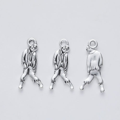 Close view of the relief and openwork details on the walking zombie metal charm
