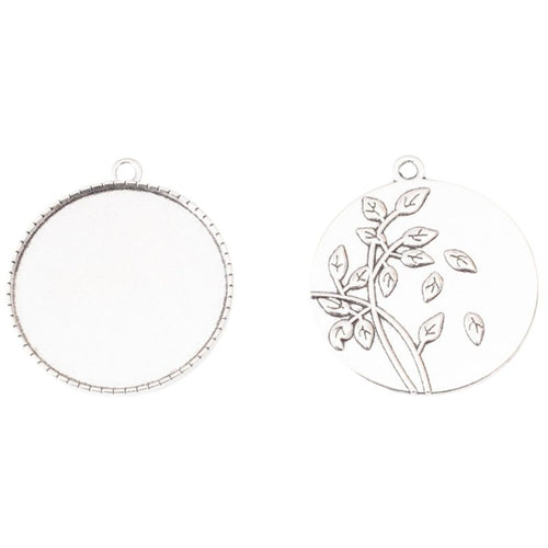 Close view of the a round recessed tray with a leafy branch relief across the reverse