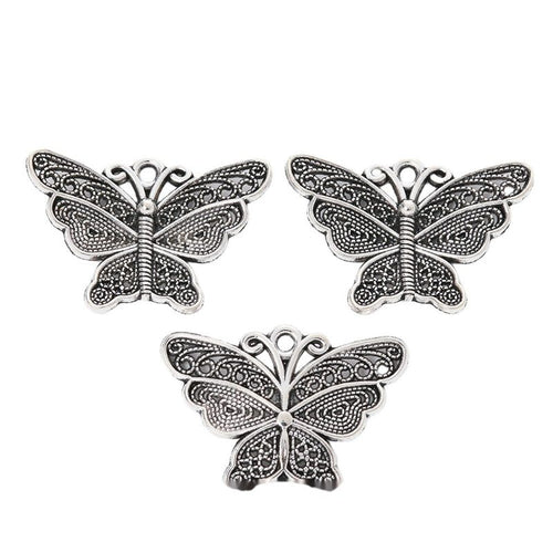 Grouped wide filigree butterfly components showing repeated front details and finish