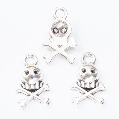 Front and reverse views of the skull and crossbones metal charms in three finishes