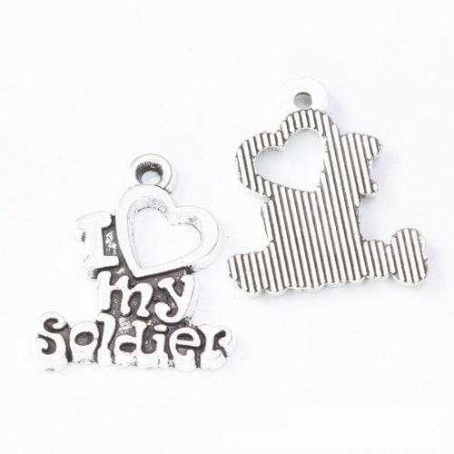 Close-up view of the i love my soldier heart metal word charms showing its front and reverse metal details.