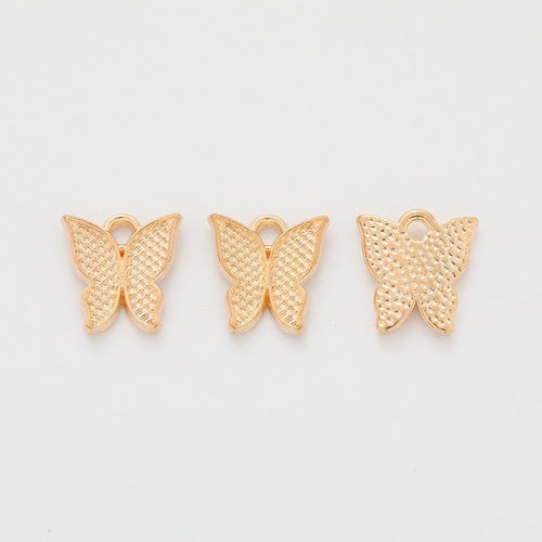 Detail view of dotted butterfly pendant showing finish variation 2