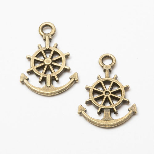 Closer product view of anchor and ship wheel charm shown against a plain background.