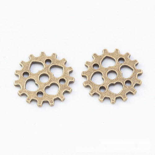 Openwork Gear metal component, reverse and front details on a white background.