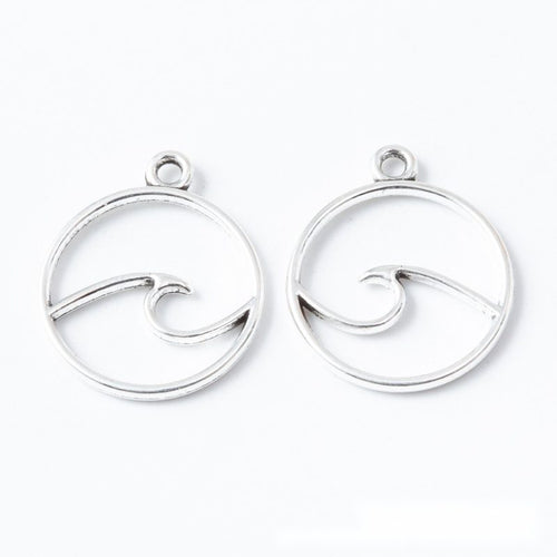 Closer product view of round ocean wave outline charm shown against a plain background.