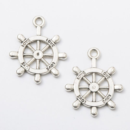 Front and reverse views of the detailed ship wheel charm