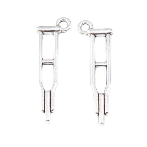Close view of the relief and openwork details on the medical tuning fork metal charm