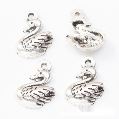 Close product view of the small swan pendant charm in two antique metal finishes