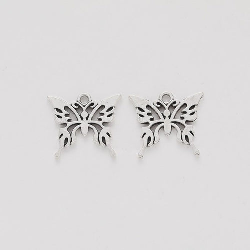 Front and reverse views of the ornate butterfly silhouette charm