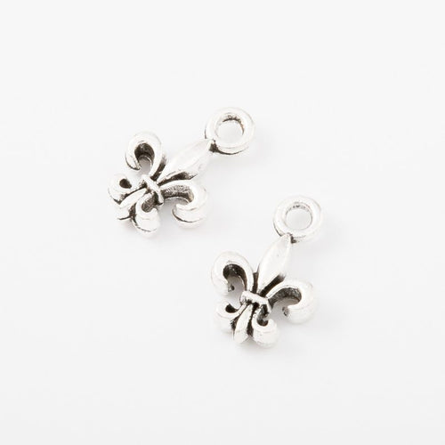 Front detail and finish comparison of the mini fleur de lis charm