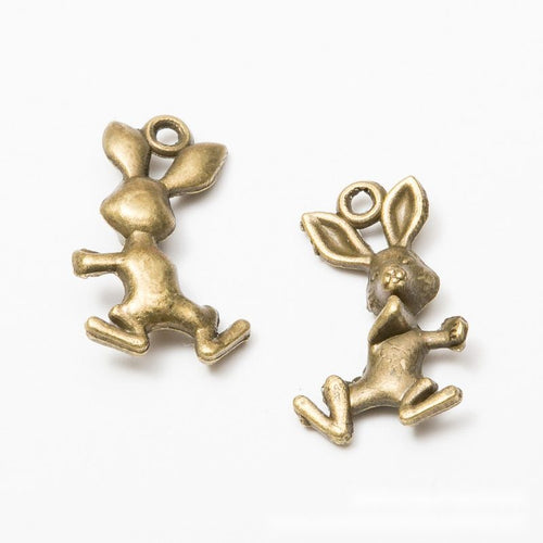 Close product view of the running rabbit metal charm in three metallic finishes