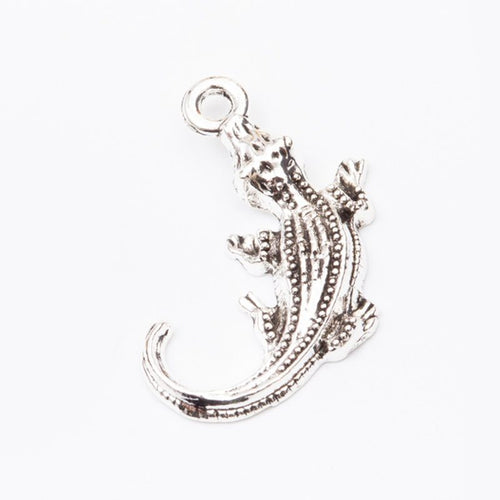 Close view of the a curled crocodile silhouette with raised scales and a top loop