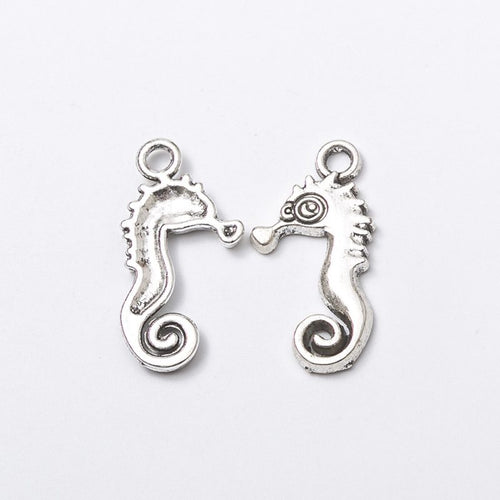 Seahorse metal component, reverse and front details on a white background.