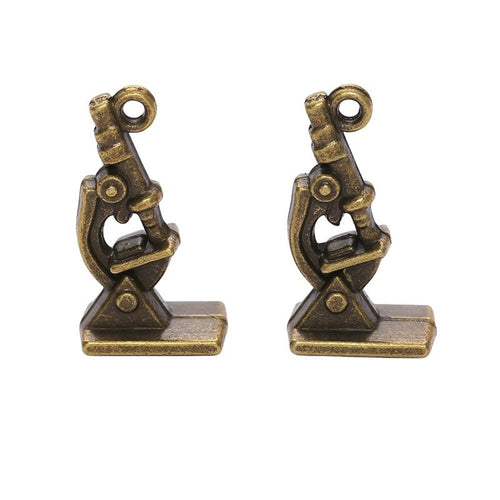 Close view of the relief and openwork details on the microscope metal charm