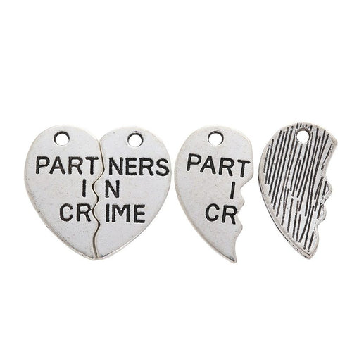 Front detail of partners in crime split heart metal charm