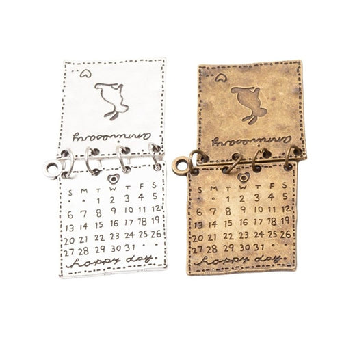 Calendar Book metal component, reverse and front details on a white background.