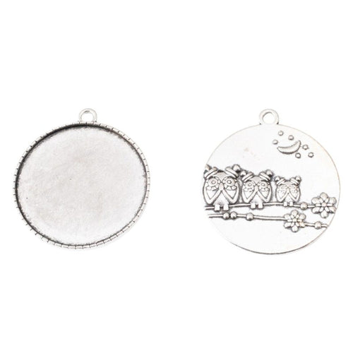 Closer view of the round recessed tray with an owl border on the reverse