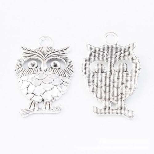 Close view showing the front and reverse details of the large layered feather owl charm